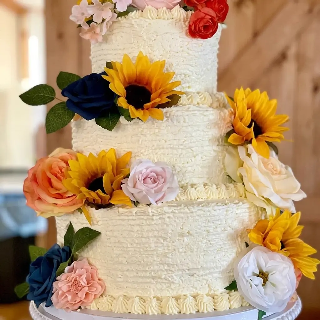 Rustic 3-tier wedding cake with sunflowers and roses made by Christy's Cakes in Whiteville NC